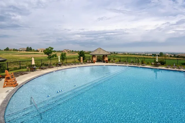 an aerial view of a city with lots of residential buildings and ocean view in back