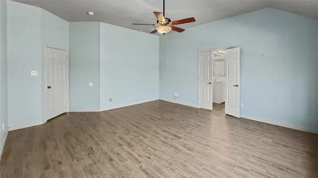 a bedroom with a large bed and a window