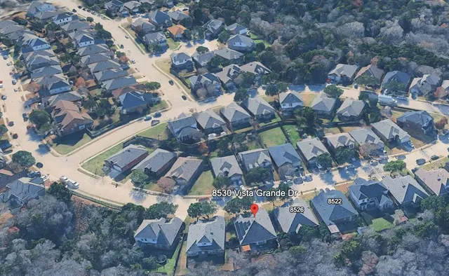 an aerial view of houses with outdoor space