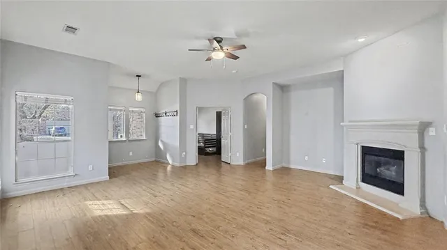 a view of a livingroom with a fireplace and window