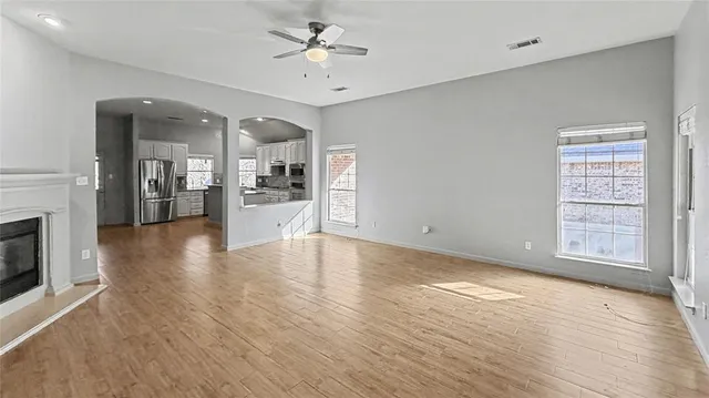 wooden floor in an empty room with a fireplace