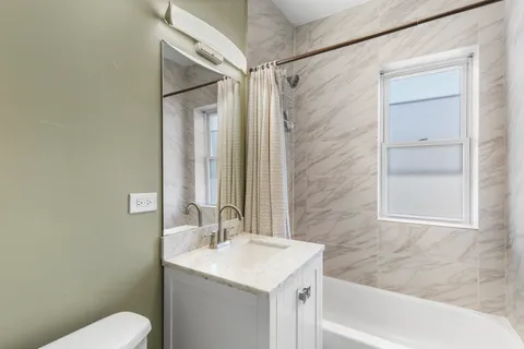 a bathroom with a shower and a sink