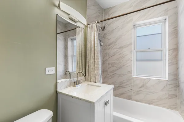 a bathroom with a shower and a sink