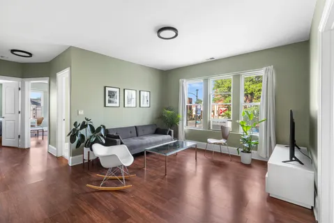 a living room with furniture and a large window