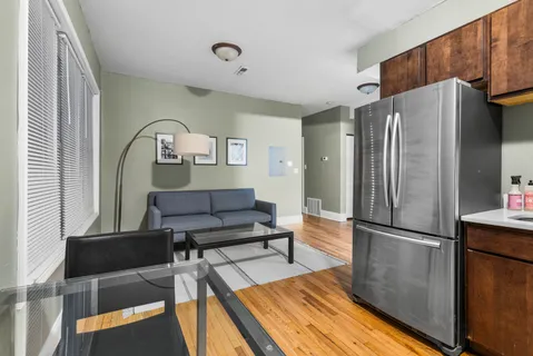 a kitchen with stainless steel appliances granite countertop a stove refrigerator sink and microwave