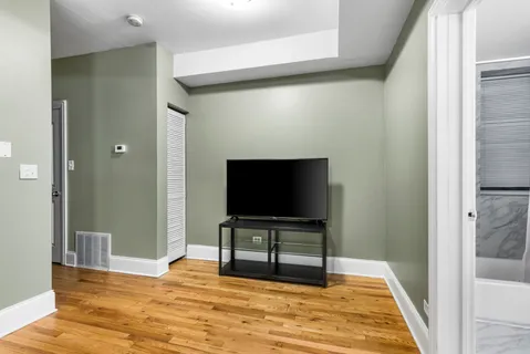 a living room with furniture a large window and a flat screen tv