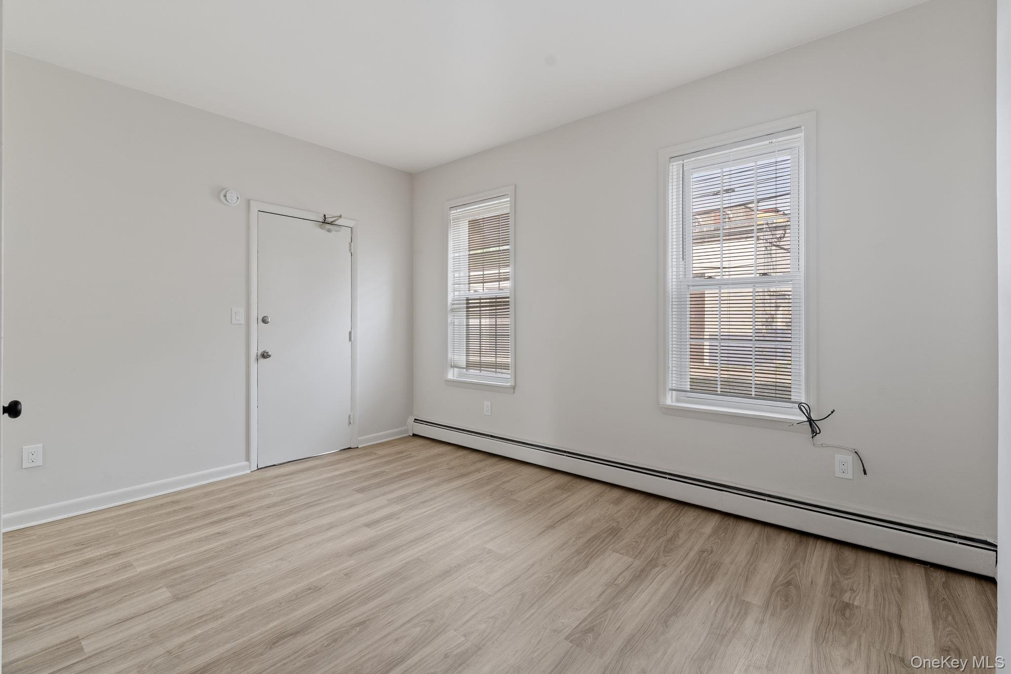 32 North Bridge Street Poughkeepsie, NY 12601 - Photo 7 of 19 a view of an empty room with wooden floor and a window