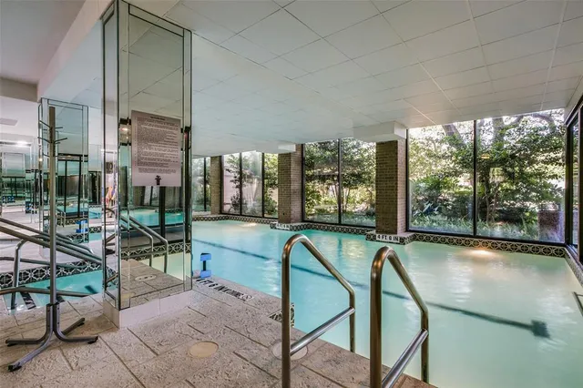 a view of a swimming pool and lounge chairs
