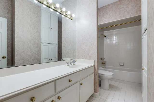 a bathroom with a double vanity sink toilet and shower