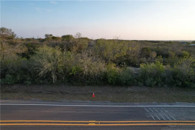 an aerial view of house with yard and mountain view in back