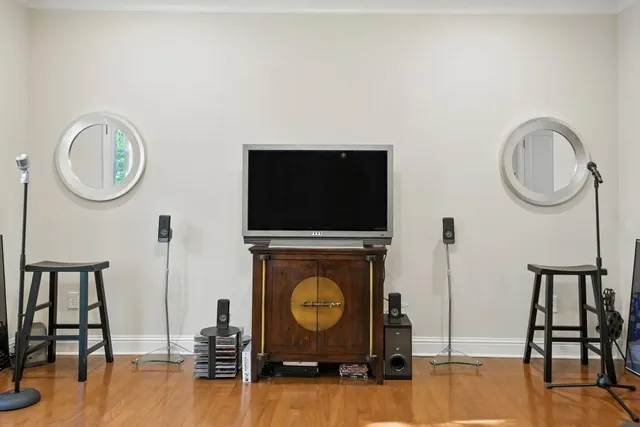 a living room with furniture a flat screen tv and a wall