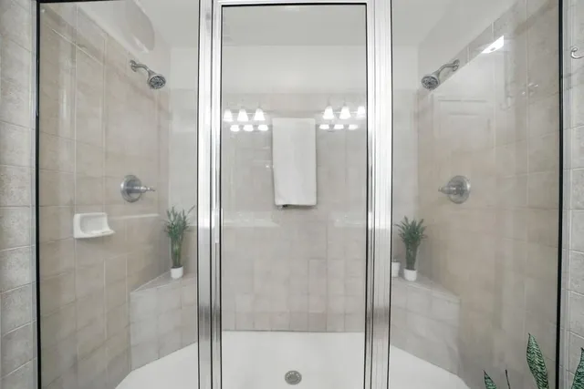 a bathroom with a glass shower door