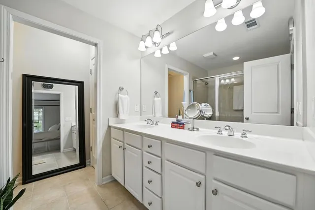 a bathroom with a sink vanity and a mirror