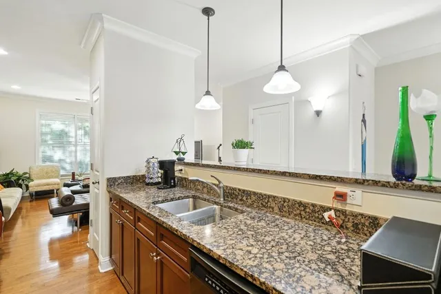 a kitchen with sink stove and living room