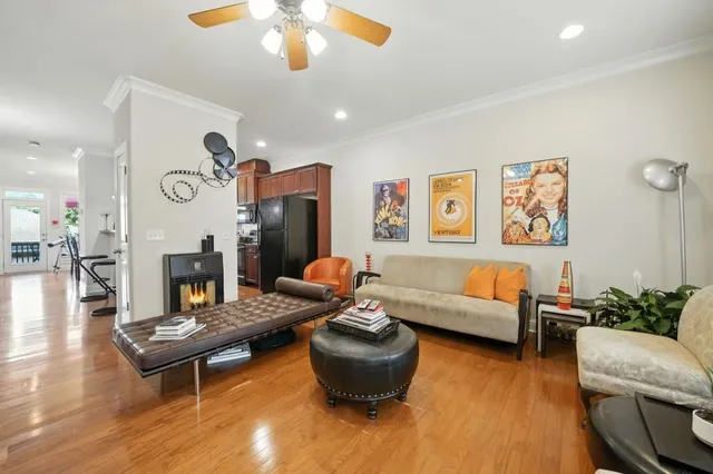 a living room with furniture and wooden floor
