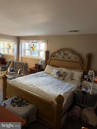 a view of a bedroom with furniture and window