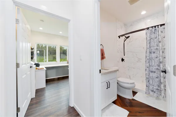 a bathroom with a sink toilet and shower