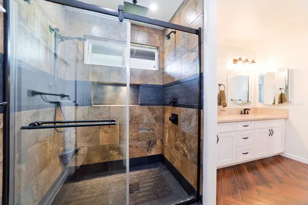 a bathroom with a double vanity sink and mirror