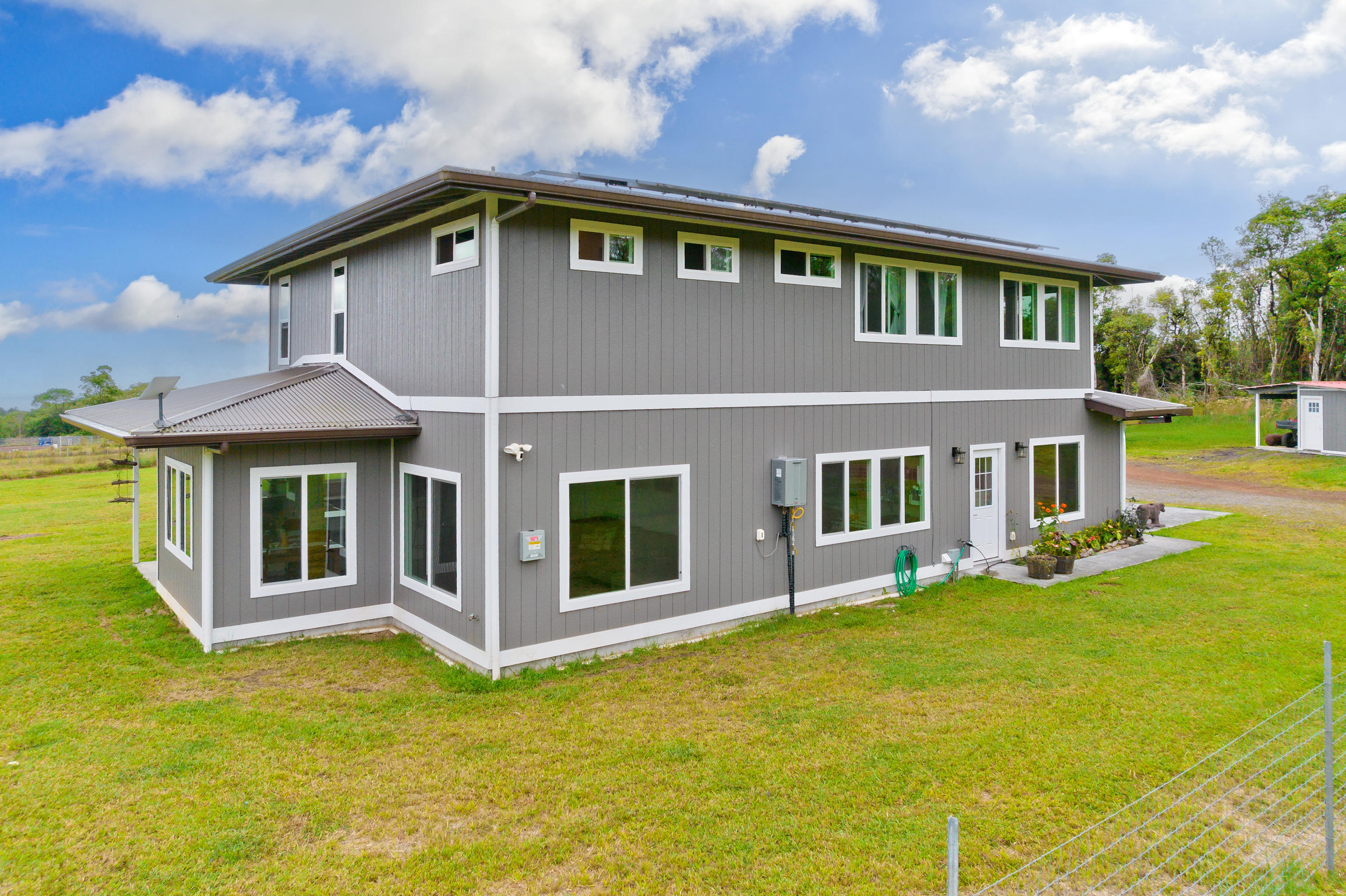 18-7970 North Lauko Road Mountain View, HI 96771 - Photo 25 of 30 a front view of a house with garden