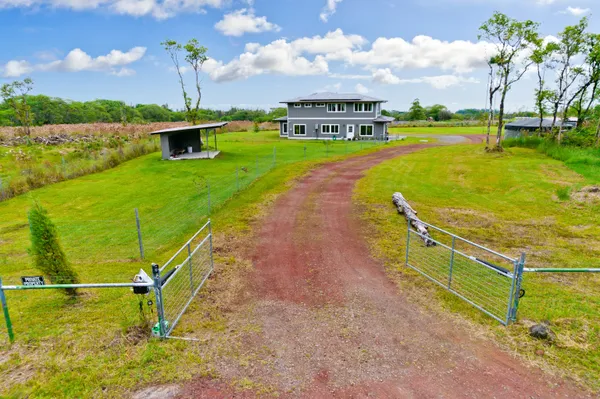 an aerial view of a house with a yard