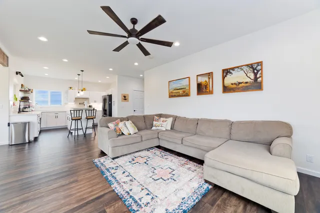 a kitchen with kitchen island granite countertop a sink appliances cabinets and a counter top space
