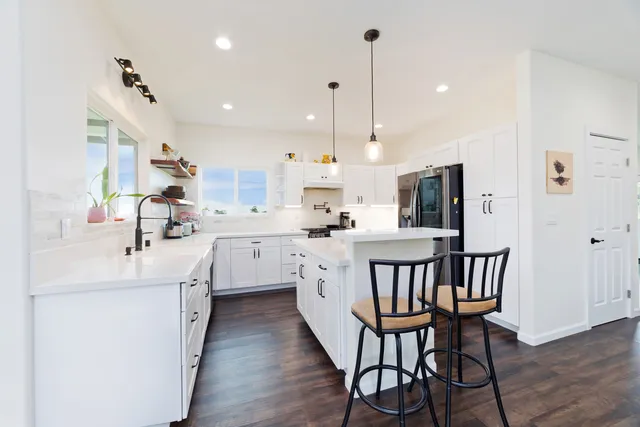 a living room with furniture and a book shelf