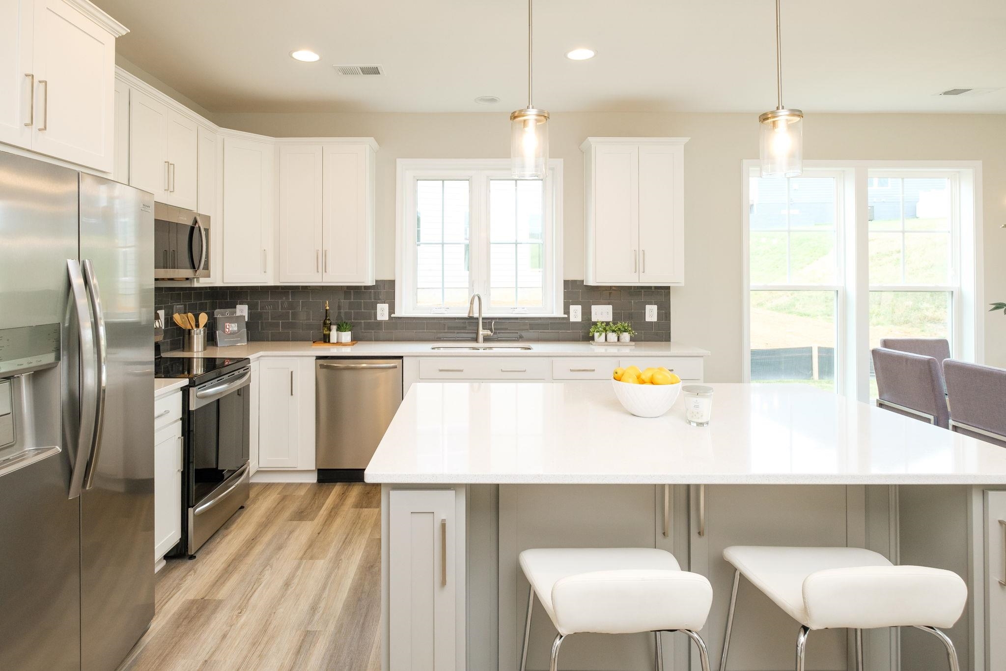 2905 Rutlege Road Harrisonburg, VA 22801 - Photo 11 of 24 a kitchen with a refrigerator a stove a sink and white cabinets with wooden floor