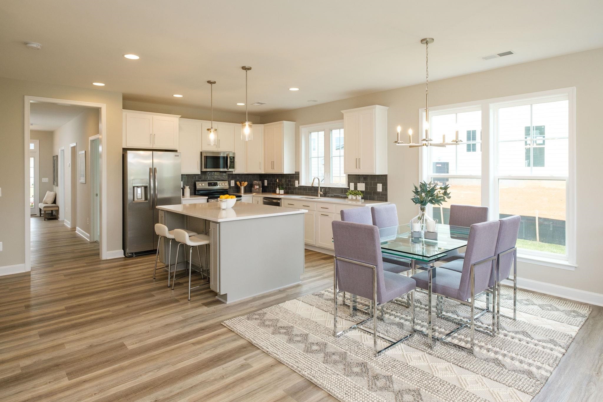 2905 Rutlege Road Harrisonburg, VA 22801 - Photo 9 of 24 a kitchen with stainless steel appliances kitchen island granite countertop a stove a refrigerator a table and chairs with wooden floor