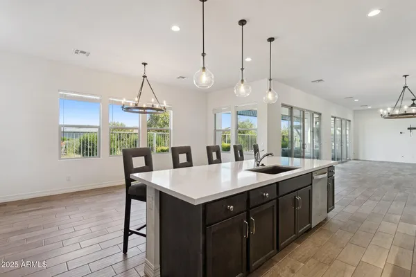a kitchen with a sink a counter space and wooden floor
