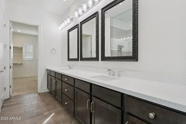 a bathroom with a double vanity sink and a mirror