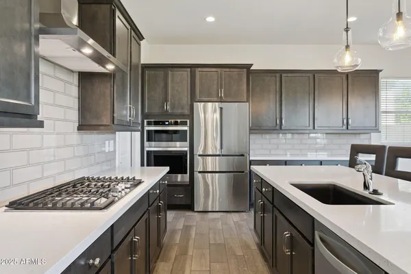 a kitchen with a sink stove and refrigerator