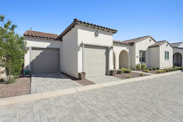 a view of a white house with a outdoor space