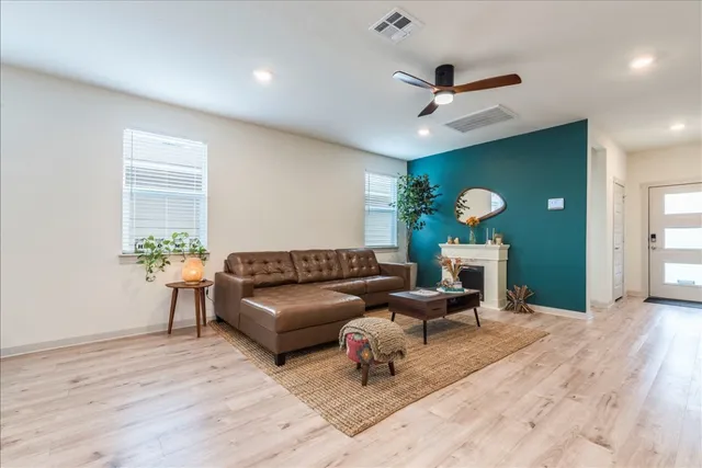 a living room with furniture and a wooden floor