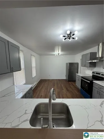 a view of kitchen with sink and natural light
