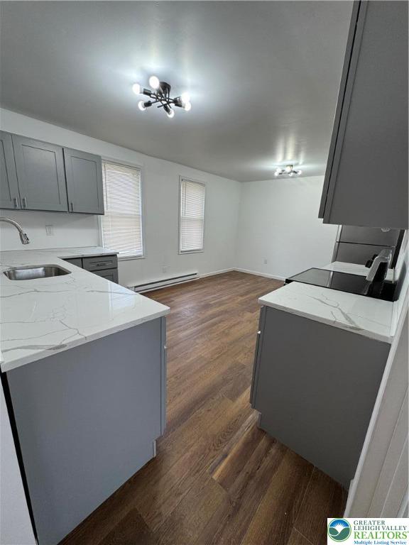 1232 South 9th Street, Unit REAR Allentown, PA 18103 - Photo 3 of 11 a kitchen with granite countertop a sink a stove and cabinets