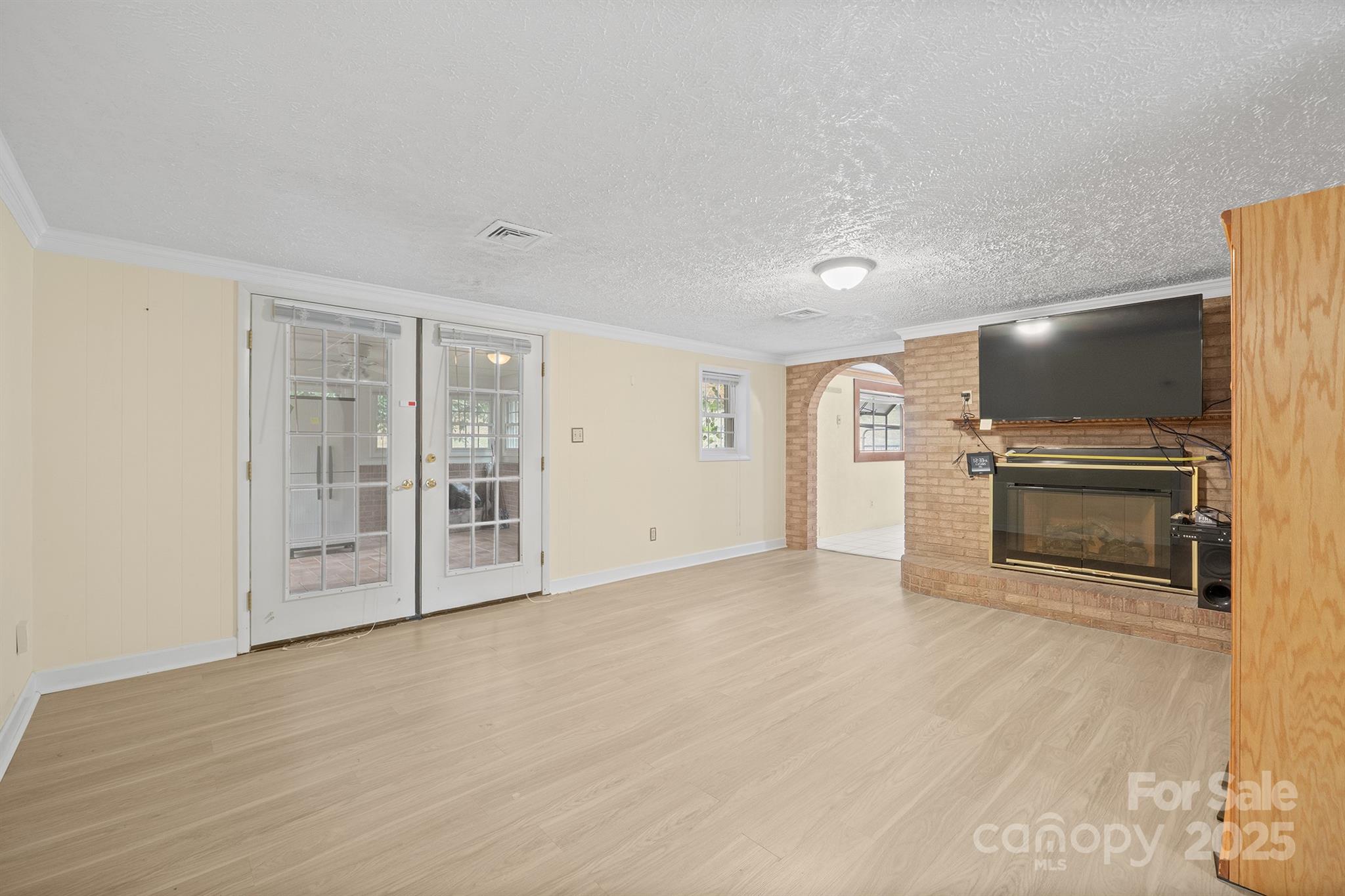 5260 Rifle Range Road Conover, NC 28613 - Photo 12 of 27 a view of an empty room with a fireplace and a window