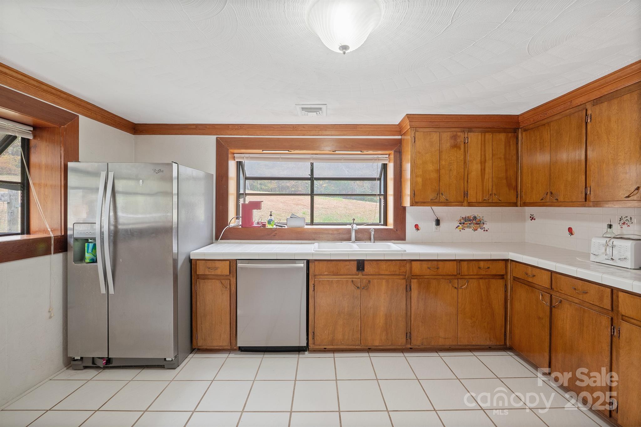 5260 Rifle Range Road Conover, NC 28613 - Photo 16 of 27 a kitchen with stainless steel appliances granite countertop a refrigerator and a sink