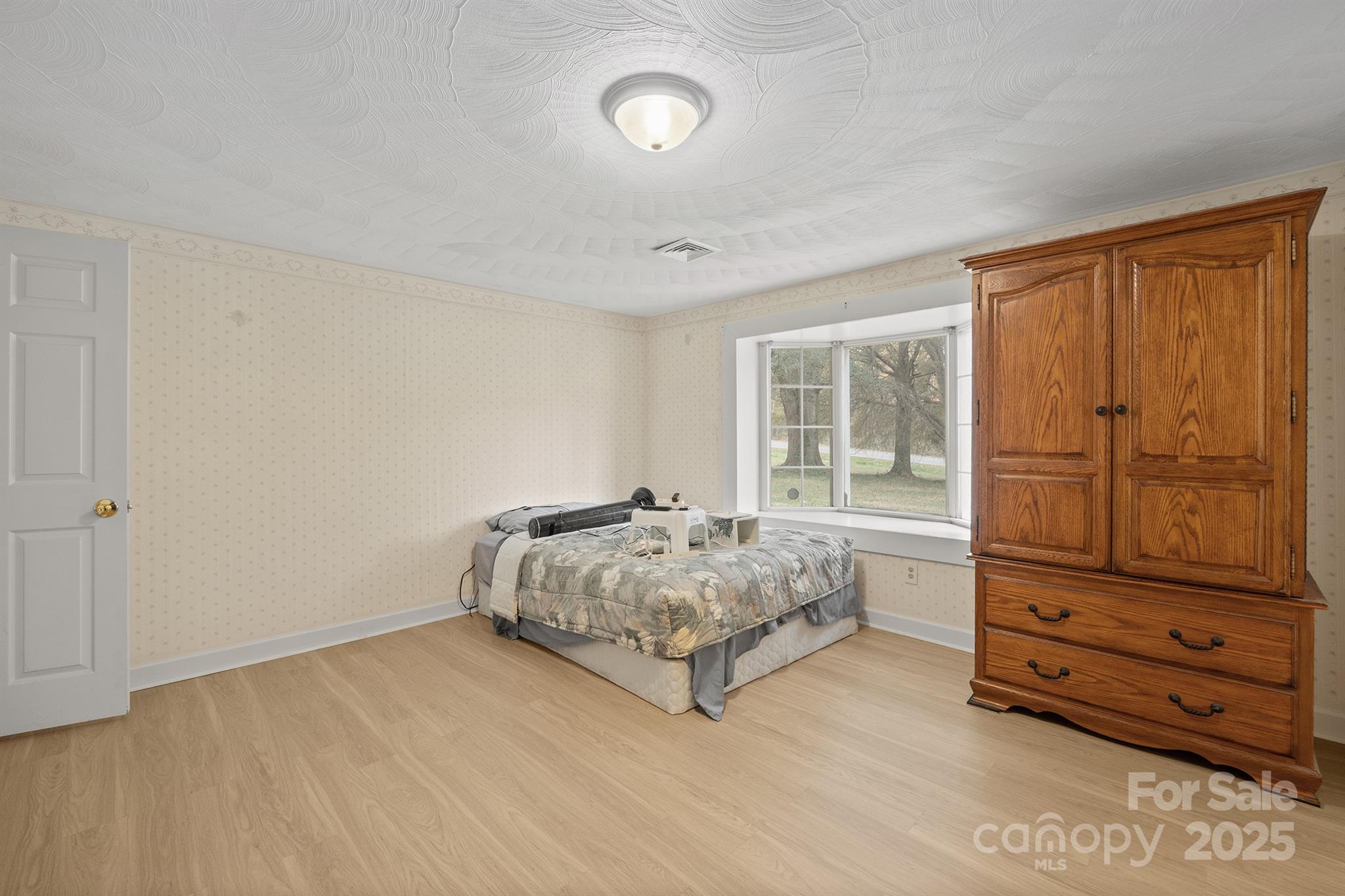 5260 Rifle Range Road Conover, NC 28613 - Photo 20 of 27 a spacious bedroom with a bed and cabinet