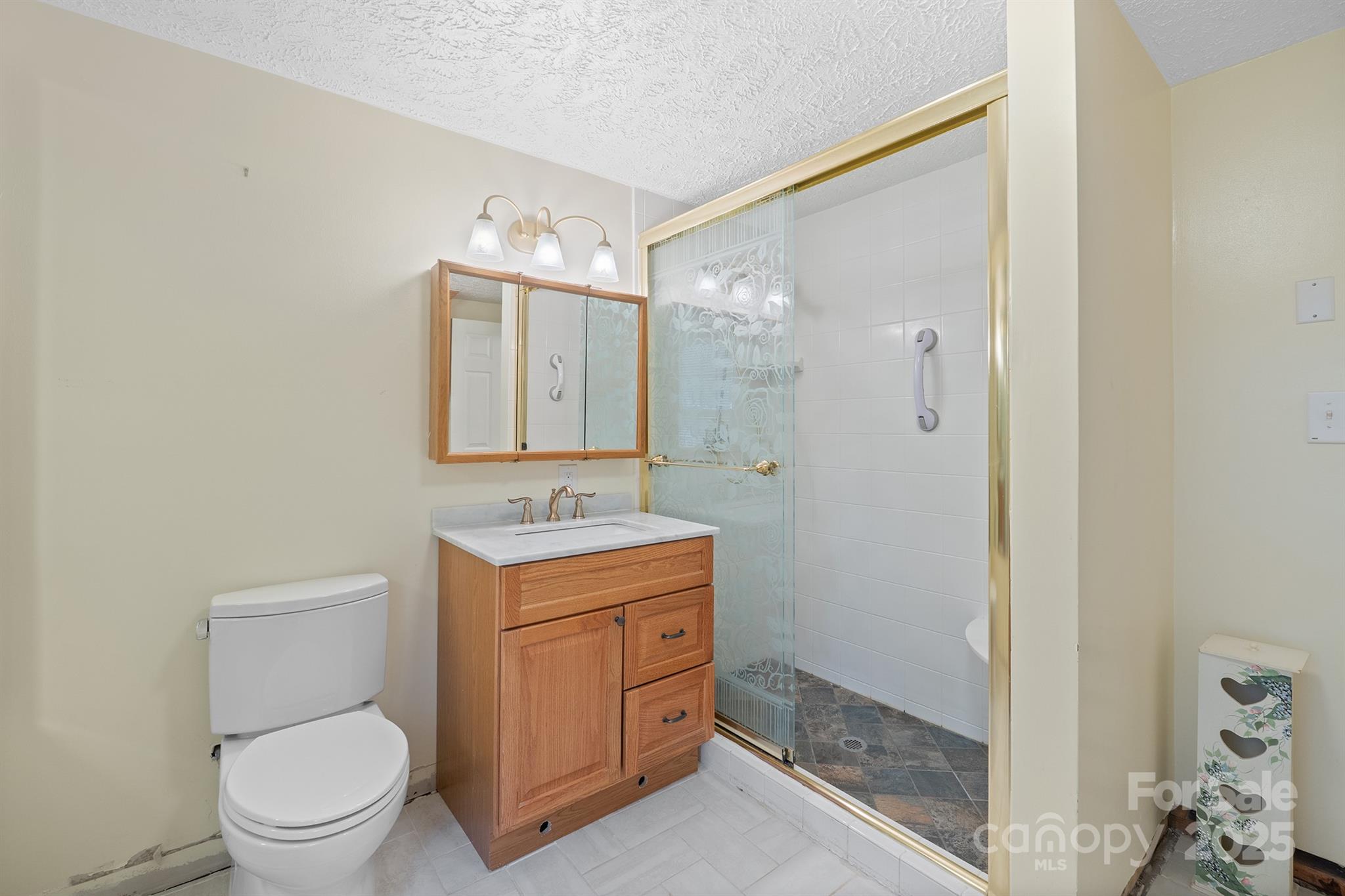5260 Rifle Range Road Conover, NC 28613 - Photo 7 of 27 a bathroom with a granite countertop toilet a sink and a mirror