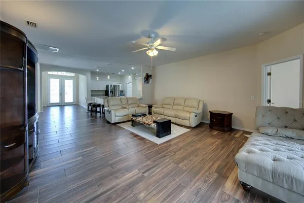 a living room with furniture and a chandelier