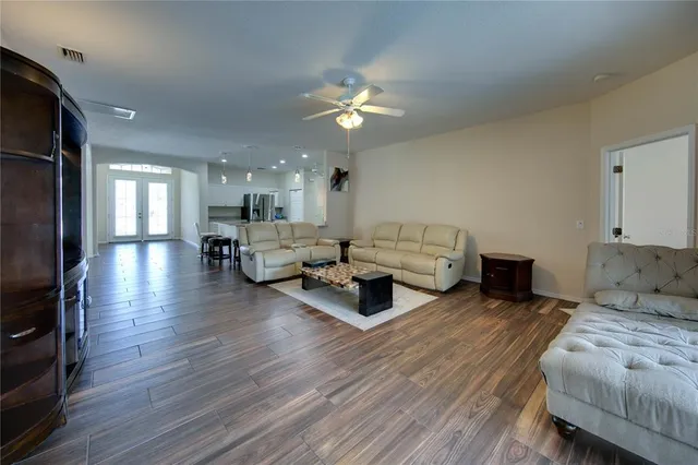 a living room with furniture and a chandelier