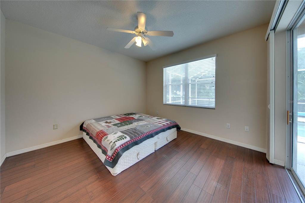 5291 Echo Lane Sarasota, FL 34233 - Photo 14 of 32 a bedroom with a bed and a chandelier