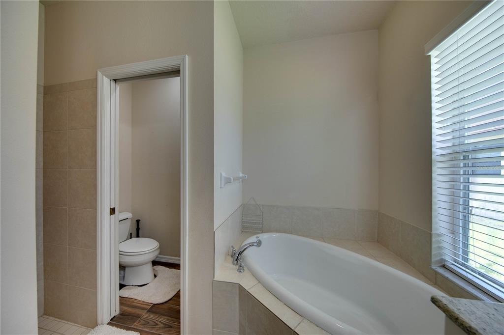 5291 Echo Lane Sarasota, FL 34233 - Photo 17 of 32 a bath room with a toilet and a bath tub