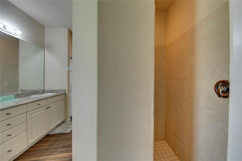 5291 Echo Lane Sarasota, FL 34233 - Photo 18 of 32 a bathroom with a granite countertop sink and a mirror