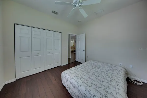 a big room with closet and chandelier fan