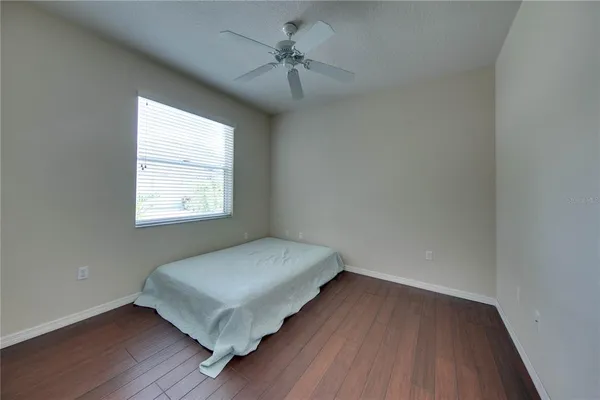a view of room with window and wooden floor