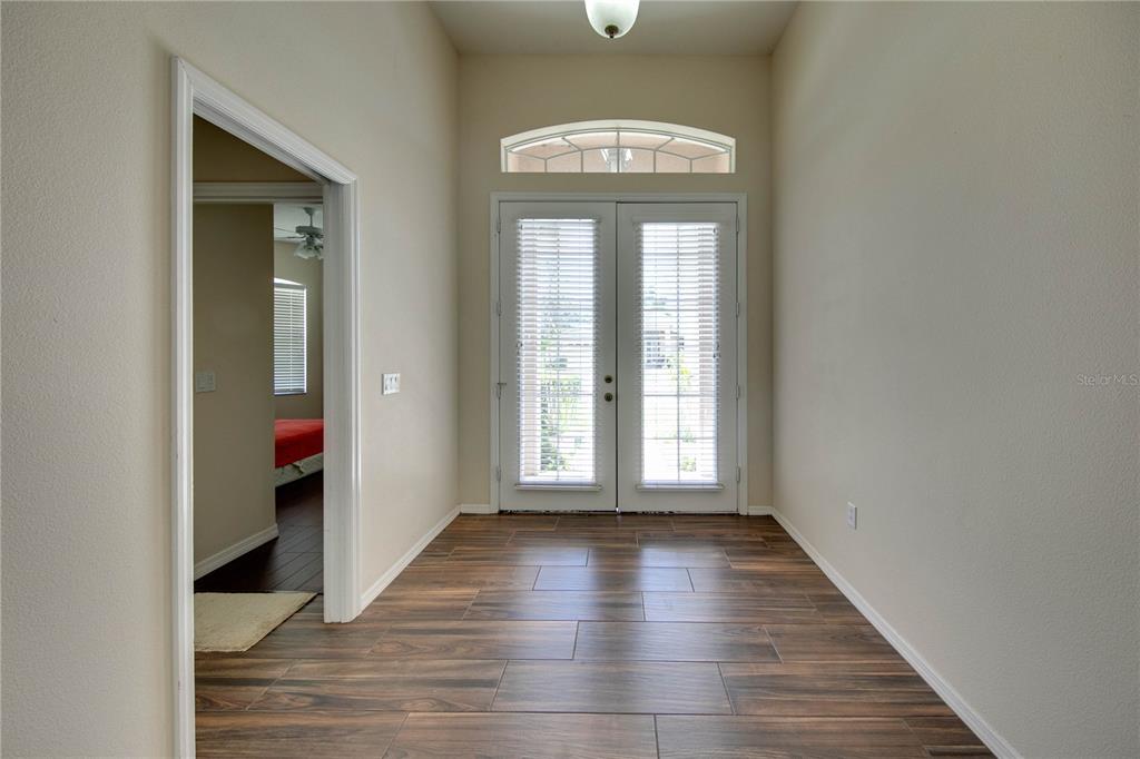 5291 Echo Lane Sarasota, FL 34233 - Photo 3 of 32 a view of an empty room with wooden floor and a window