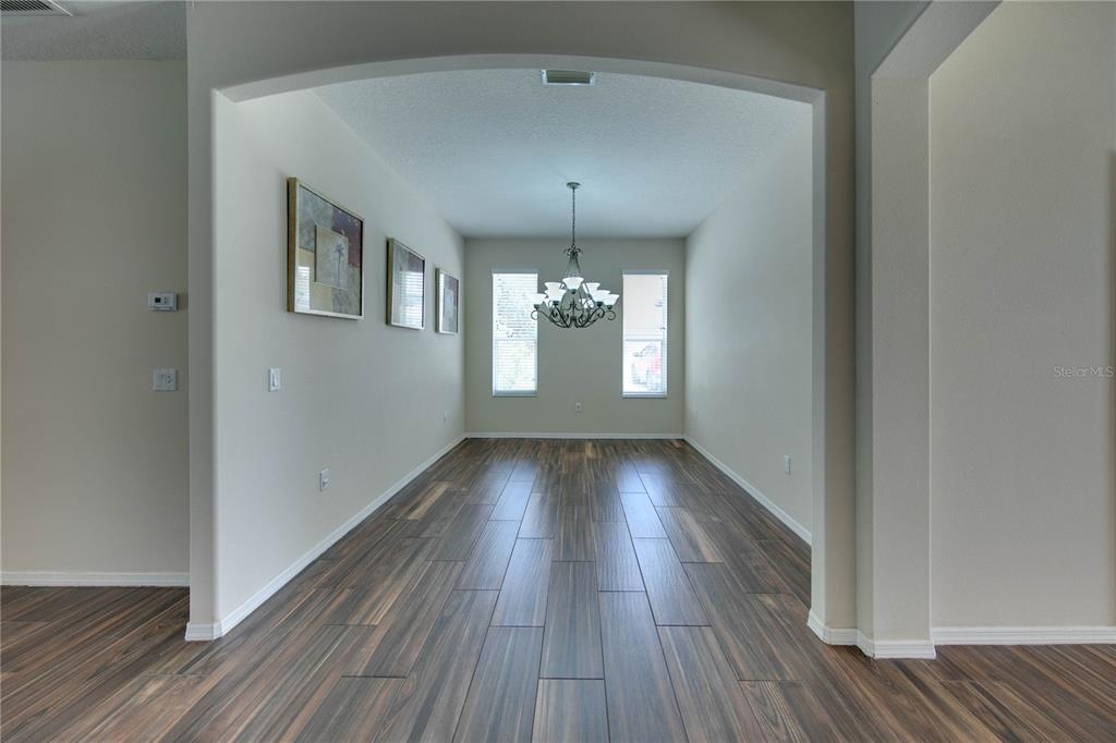 5291 Echo Lane Sarasota, FL 34233 - Photo 4 of 32 a view of gallery with wooden floor