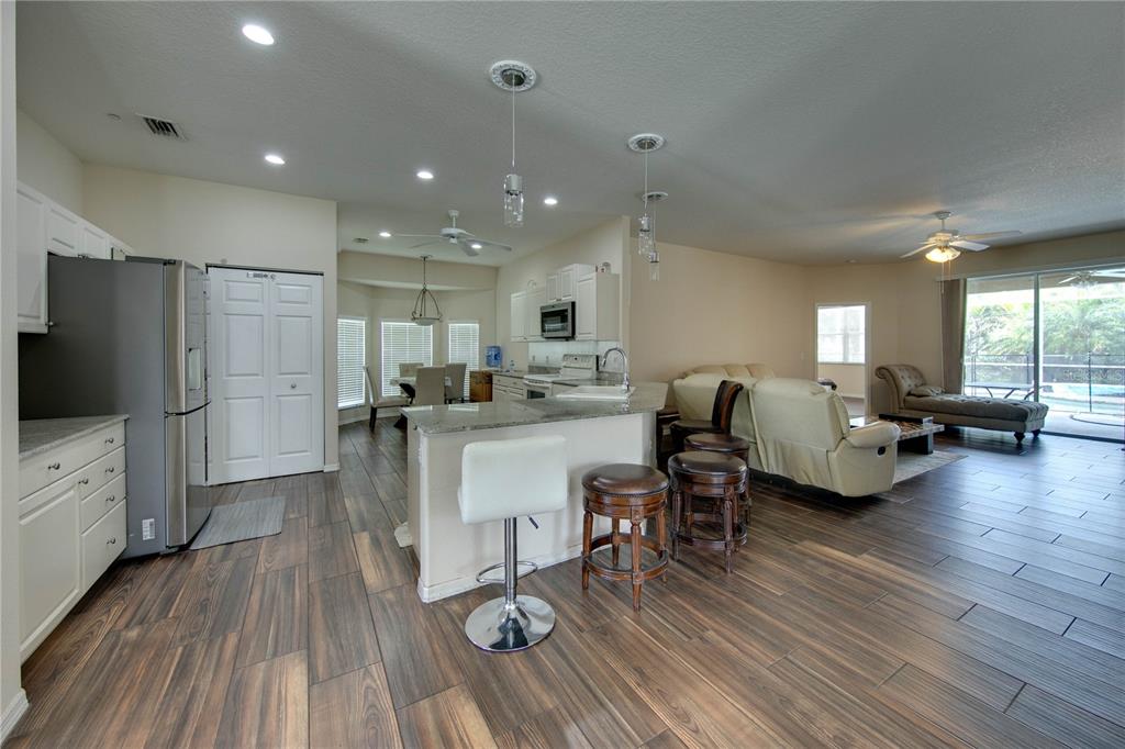 5291 Echo Lane Sarasota, FL 34233 - Photo 6 of 32 a living room with furniture and a flat screen tv