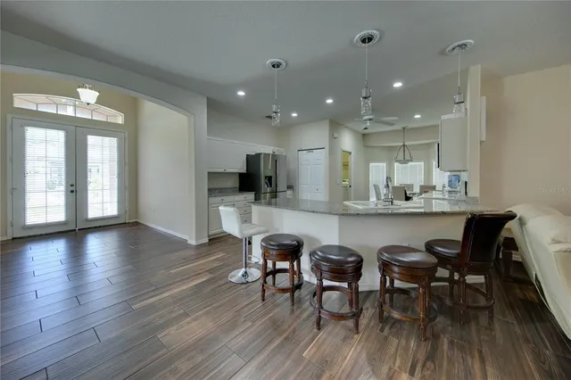 a view of kitchen with dining table chairs and wooden floor